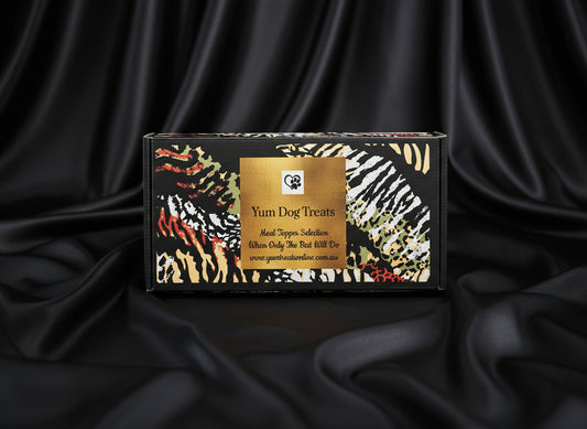 Yum Dog Treats packaging with animal print design on a black satin surface